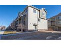 Modern multi-story home with neutral siding, stone accents, and a well-manicured lawn at 11250 Florence St # 28F, Commerce City, CO 80640