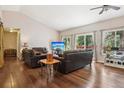 Comfortable living room with hardwood floors, large windows providing ample light, and vaulted ceilings at 8095 Bannock Dr, Larkspur, CO 80118