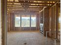 Unfinished interior displays the framed construction with large windows bringing in natural light at 901 Coal Bank Trl, Castle Rock, CO 80104