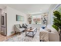 Well-lit living room showcasing custom built-ins, modern decor, and hardwood flooring at 902 Poplar St, Denver, CO 80220