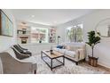 Bright living room features built-in shelving, large windows, and contemporary furniture arrangement at 902 Poplar St, Denver, CO 80220