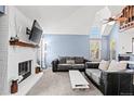 Cozy living room with a white brick fireplace and comfortable seating area at 14271 E Dickinson Dr # F, Aurora, CO 80014