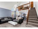 Bright living room with vaulted ceilings, fireplace, and modern decor at 14271 E Dickinson Dr # F, Aurora, CO 80014