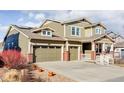 Inviting home with a well-manicured lawn, three-car garage, solar panels, and a cozy front porch at 19503 W 58Th Pl, Golden, CO 80403