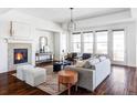 Cozy living room features a fireplace, hardwood floors, lots of natural light, and neutral decor at 19503 W 58Th Pl, Golden, CO 80403