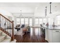 Bright, open-concept living room featuring hardwood floors, large windows, and stylish modern furnishings at 19503 W 58Th Pl, Golden, CO 80403