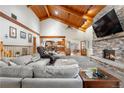Spacious living room with vaulted wood ceilings and a cozy fireplace for a relaxing atmosphere at 97 S Coolidge St, Aurora, CO 80018