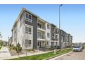 Attractive apartment building with a contemporary design, featuring balconies, and well-maintained landscaping at 6153 N Ceylon St # 303, Denver, CO 80249