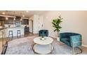 Comfortable living room offers cozy seating, soft carpet, and access to the kitchen at 6153 N Ceylon St # 303, Denver, CO 80249