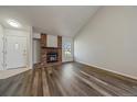 Spacious living room with stylish modern floors, cozy brick fireplace, and a bright window for natural light at 8329 W 90Th Pl, Westminster, CO 80021