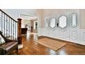 Welcoming foyer with hardwood floors, decorative front door, and view into the adjacent living space at 5329 S Geneva St, Englewood, CO 80111