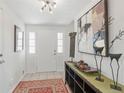 Bright entryway showcasing tiled floors, modern lighting, and stylish console table decor at 2752 S Heather Gardens Way, Aurora, CO 80014