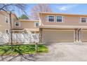 Inviting townhouse with a two-car garage and well-maintained front yard and a beautiful stone detail at 2752 S Heather Gardens Way, Aurora, CO 80014