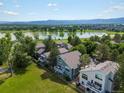 Stunning aerial view of the property, showcasing its proximity to a lake, golf course, and mountains at 7400 W Grant Ranch Blvd # 19, Littleton, CO 80123