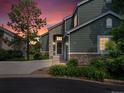 Charming two-story home with stone accents, attached garage during sunset at 7400 W Grant Ranch Blvd # 19, Littleton, CO 80123