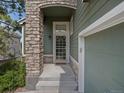 Close up of the home's front door, featuring stone accents and a well-maintained entrance at 7400 W Grant Ranch Blvd # 19, Littleton, CO 80123