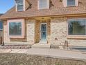 Close-up of a brick home's front entrance, highlighting the detailed brickwork and inviting doorway at 3873 W 98Th Ave, Westminster, CO 80031