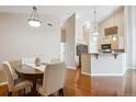 Open-concept dining room features hardwood floors and pendant lighting at 8638 Gold Peak Dr # D, Highlands Ranch, CO 80130