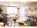 Bright living area showcasing an open floor plan, elegant dining decor, and a large window with city views at 1625 Larimer St # 2708, Denver, CO 80202