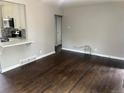 Inviting living room with rich hardwood floors and a view into the adjacent kitchen space at 1283 Lipan Dr, Denver, CO 80221