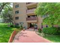 Inviting condo entrance with manicured landscaping and walking path at 3675 S Cherokee S St # 710, Englewood, CO 80110