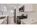 Modern kitchen features white cabinets, stainless steel appliances, and sleek countertops at 5090 Tejon St, Denver, CO 80221