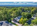 Overhead shot showing home nestled among dense foliage with other homes in the distance at 5795 Oak Creek Ln, Greenwood Village, CO 80121