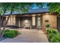 Charming single-Gathering home featuring a brick facade and cozy front porch entrance at 5795 Oak Creek Ln, Greenwood Village, CO 80121