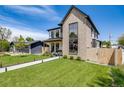Beautiful two-story home featuring modern design, lush lawn, inviting walkway, and a detached garage on the property at 2540 Jay St, Edgewater, CO 80214