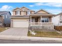 Two-story house with a beige exterior, front porch, and attached garage at 13735 Steele Ct, Thornton, CO 80602