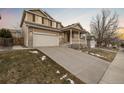 Two-story house with a driveway, attached garage, and landscaping at 13735 Steele Ct, Thornton, CO 80602