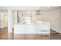 Eat in kitchen with white cabinets and a large island at 7010 W 44Th Ave, Wheat Ridge, CO 80033