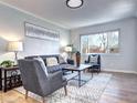 Inviting living room with modern decor, large window, and comfortable seating arrangement at 3033 Leyden St, Denver, CO 80207