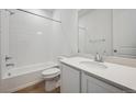 Bathroom featuring a shower and tub combination, sleek vanity, and modern fixtures at 9061 Telluride Ct, Commerce City, CO 80022