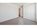 Neutral bedroom offers carpeting, closet, and ample natural light at 9061 Telluride Ct, Commerce City, CO 80022