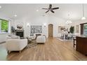 Expansive living room featuring vaulted ceilings, a fireplace, and open access to the dining area at 1235 S Balsam St, Lakewood, CO 80232