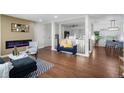 Inviting living room with an electric fireplace, hardwood floors, and an open layout at 2996 S Sheridan Blvd, Denver, CO 80227