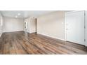 Inviting living area featuring wood-look floors, neutral paint, and ample space for furnishings at 1001 Victor St, Aurora, CO 80011