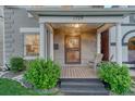 Inviting front porch with wooden floors, decorative pillars, and stylish seating area at 1729 N Clarkson St, Denver, CO 80218