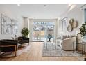 Bright living room with modern furnishings, light hardwood floors, and access to outdoor patio at 467 Harrison St, Denver, CO 80206