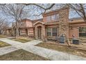 Charming exterior of a two-story home featuring a stone accent wall, covered entrance, and well-maintained landscaping at 15501 E 112Th Ave # 15C, Commerce City, CO 80022