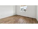 Bright bedroom with wood-look flooring and a window at 9661 Ceylon St, Commerce City, CO 80022