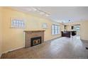 Cozy living room featuring a brick fireplace and large windows at 321 S Gilpin St, Denver, CO 80209