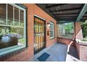 Inviting front porch features classic brickwork, tiled floor, and a secure entrance at 321 S Gilpin St, Denver, CO 80209