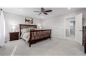 This spacious main bedroom features a ceiling fan, a queen bed, and bedside tables at 5957 N Orleans St, Aurora, CO 80019
