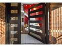 Modern home entryway with a sleek glass paneled door leading to an elegant staircase at 418 Steele St, Denver, CO 80206