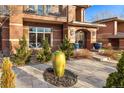 Beautifully landscaped front yard with mature shrubbery and a unique oversized decorative urn feature at 418 Steele St, Denver, CO 80206