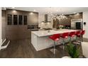 A gourmet kitchen with a large center island, stainless steel appliances, and modern lighting at 418 Steele St, Denver, CO 80206
