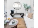 Living room features a white couch, circular mirror, and wood coffee table at 11002 Glacier Park Cir, Parker, CO 80138