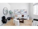 Bright living room with a white couch, coffee table, and large windows at 11002 Glacier Park Cir, Parker, CO 80138